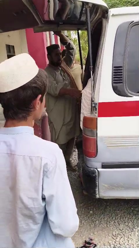 Community members around an Al Yousaf Foundation ambulance